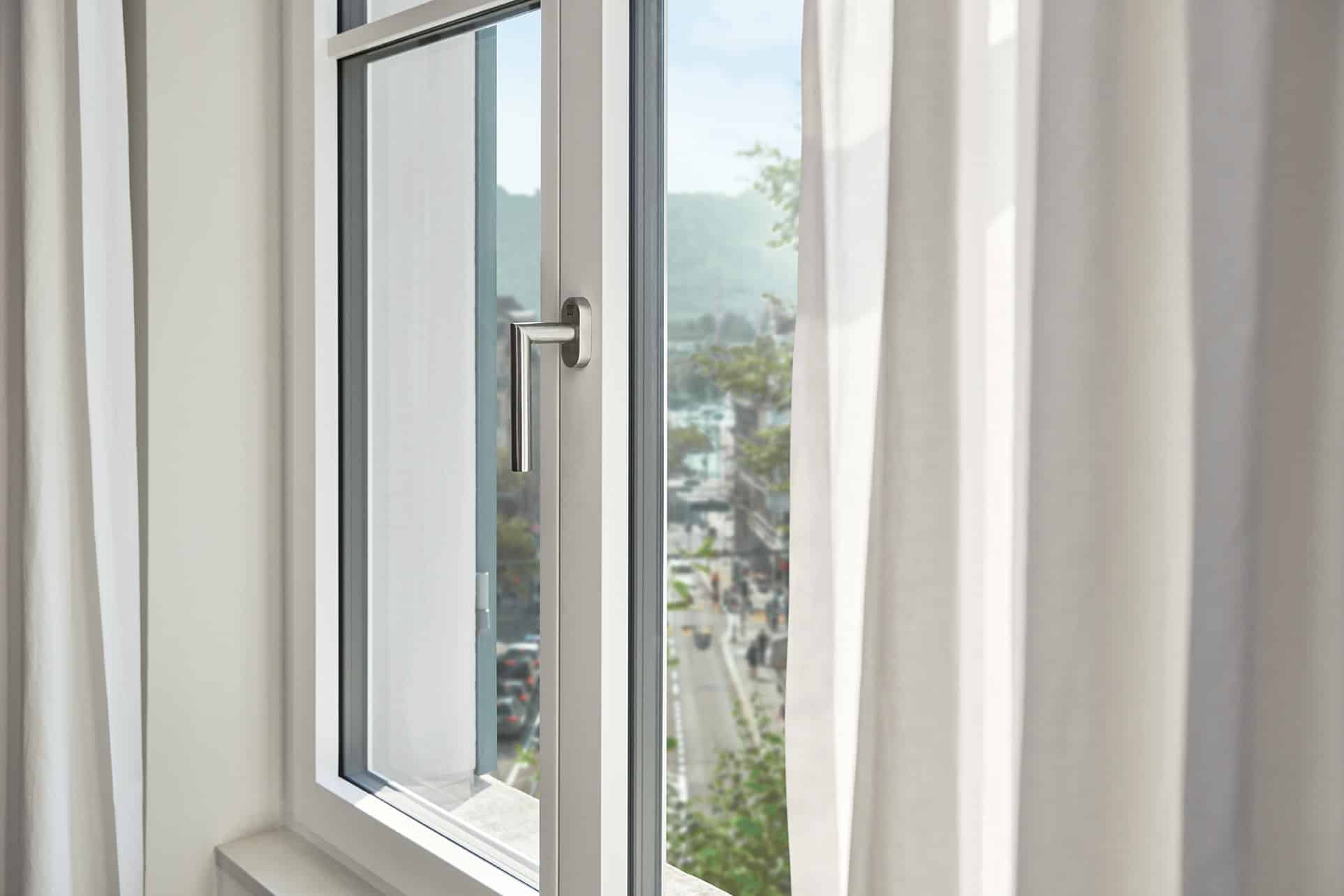 Renovationsfenster RF1 in weiss mit Aussicht auf eine befahrene Hauptstrasse